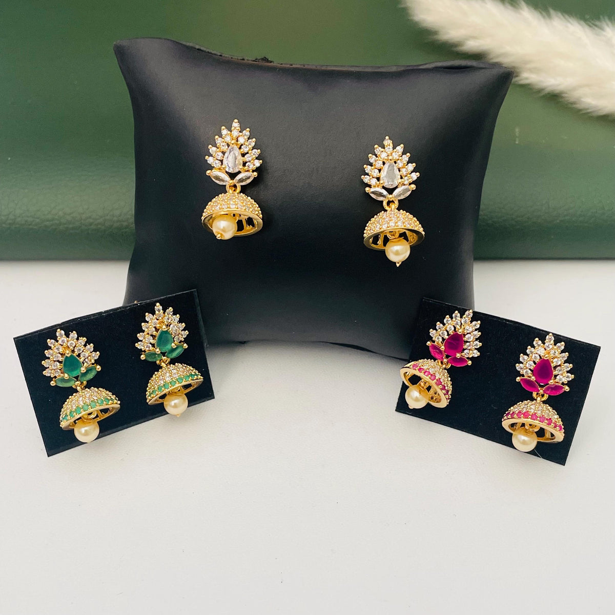 small CZ America Diamond jhumkis in green ruby and white