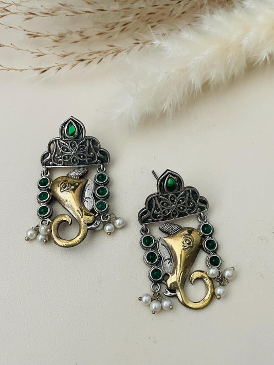 Dual tone Gold and Oxidised Ganapati high quality earrings . Decorated with high quality green gems .