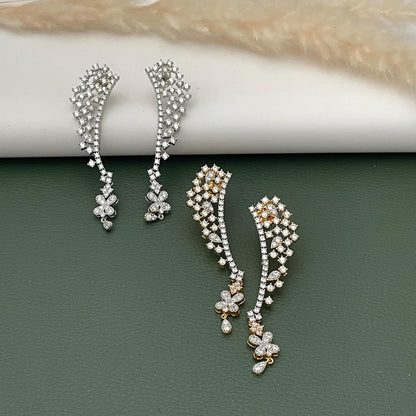 May include: Two pairs of elegant ear climbers. One pair is silver-toned, and the other is gold-toned. Both feature a cascade of small, sparkling stones and floral accents. The earrings are designed to curve up the ear, adding a touch of sophistication.