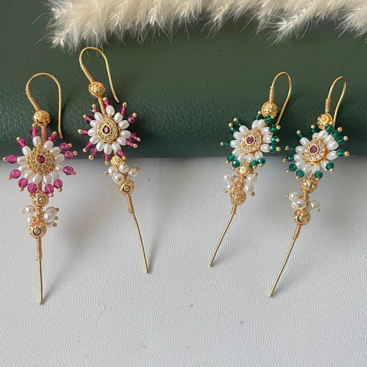 Two pairs of gold-tone middle earcuffs featuring a central floral design with white seed pearls and a small red stone. One pair is accented with magenta beads, while the other pair features green beads, both with long gold-tone wire stems.