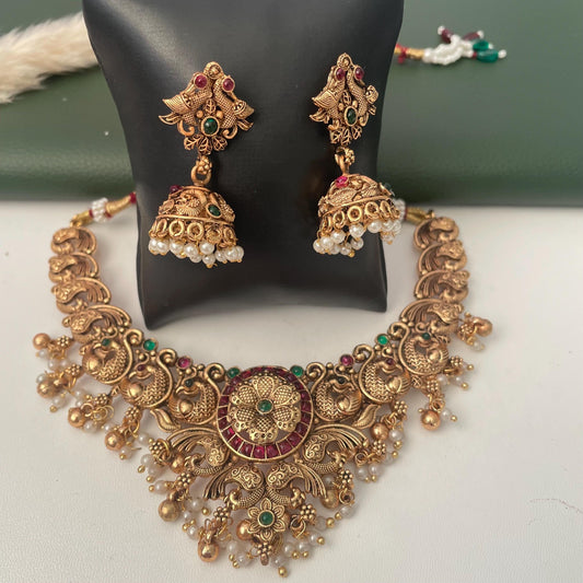 Beautiful kempstone necklace set with matching jhumkis. Antique gold plated and with flower and peacock motif