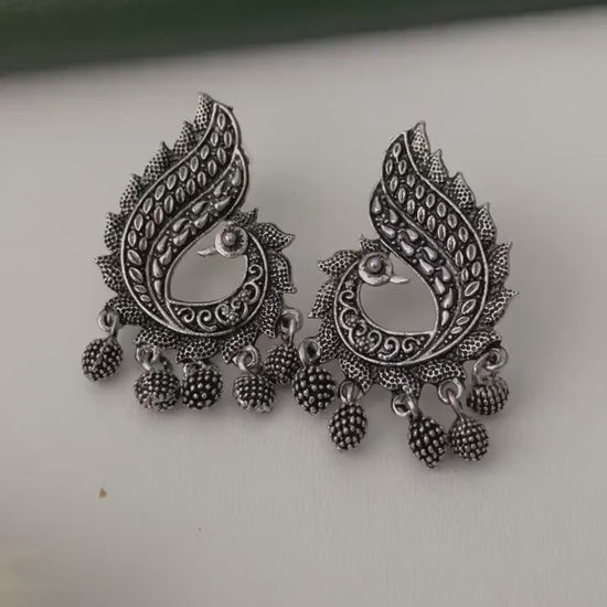 Oxidized earrings in peacock motifs.