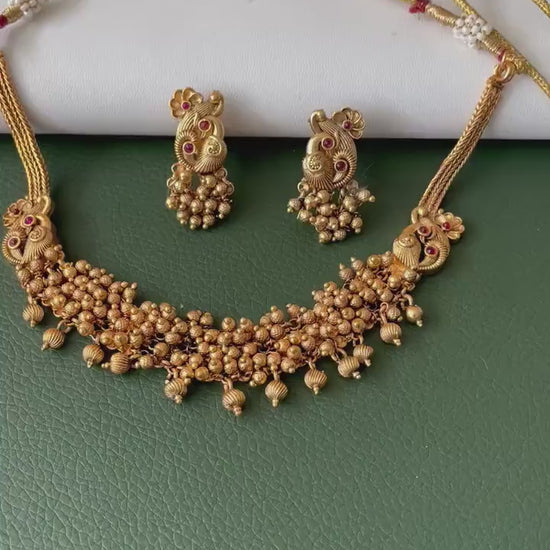Short gold plated ghungaroo necklace set with peacock earrings