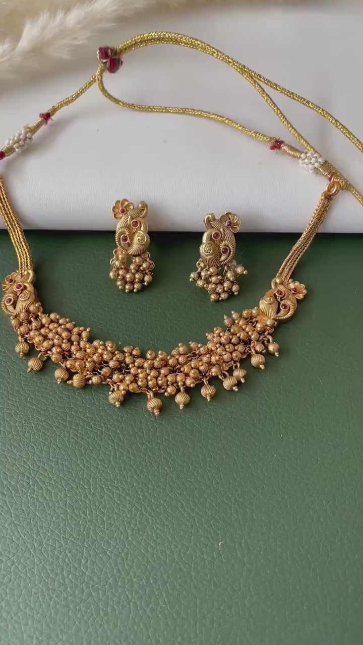 Short gold plated ghungaroo necklace set with peacock earrings