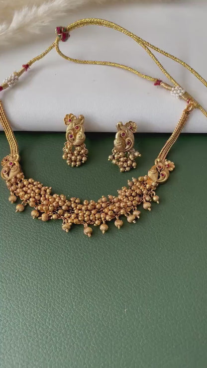 Short gold plated ghungaroo necklace set with peacock earrings