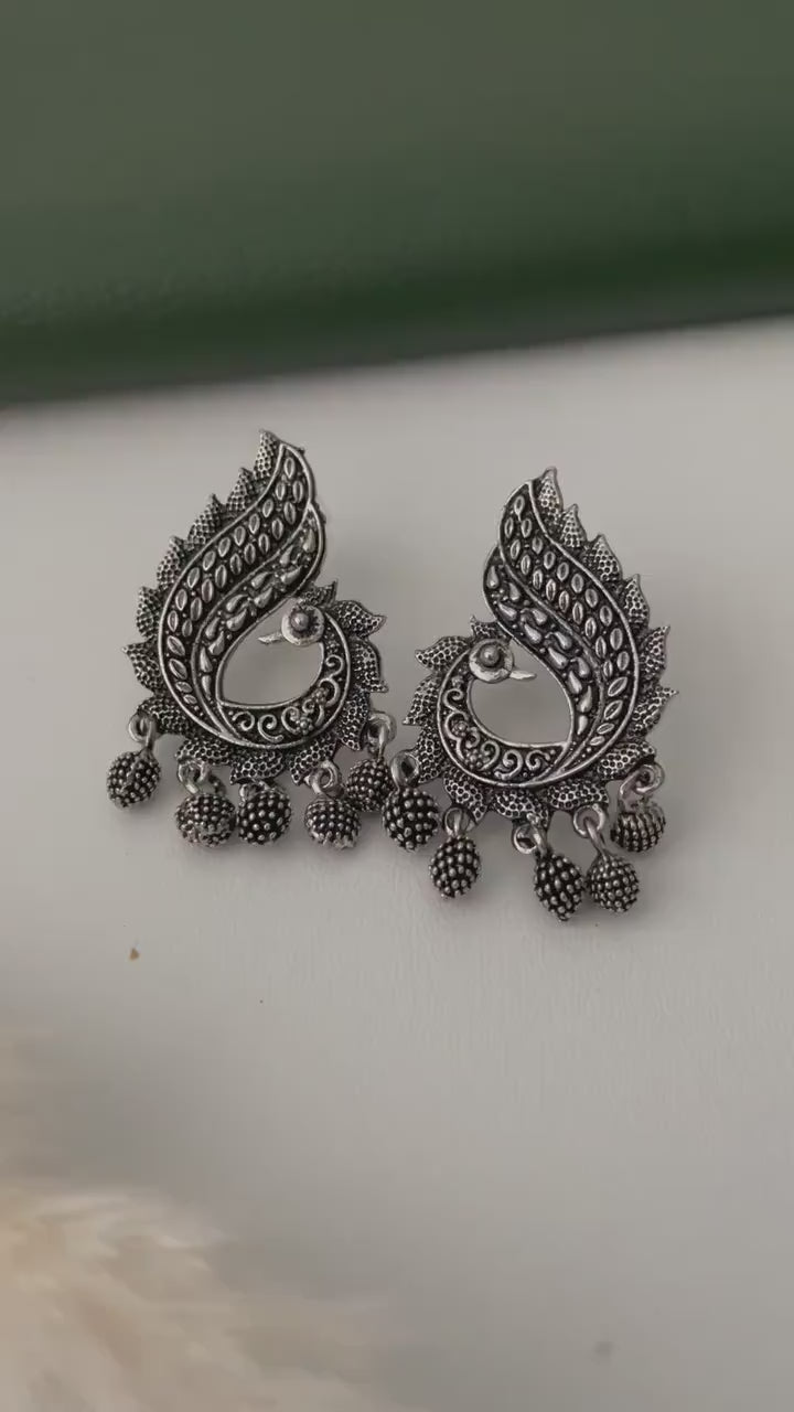 Oxidized earrings in peacock motifs.