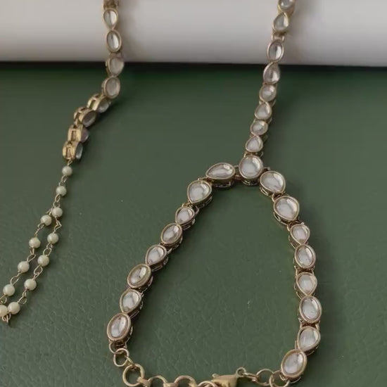 Antique gold colored kundan and pearl haath panja